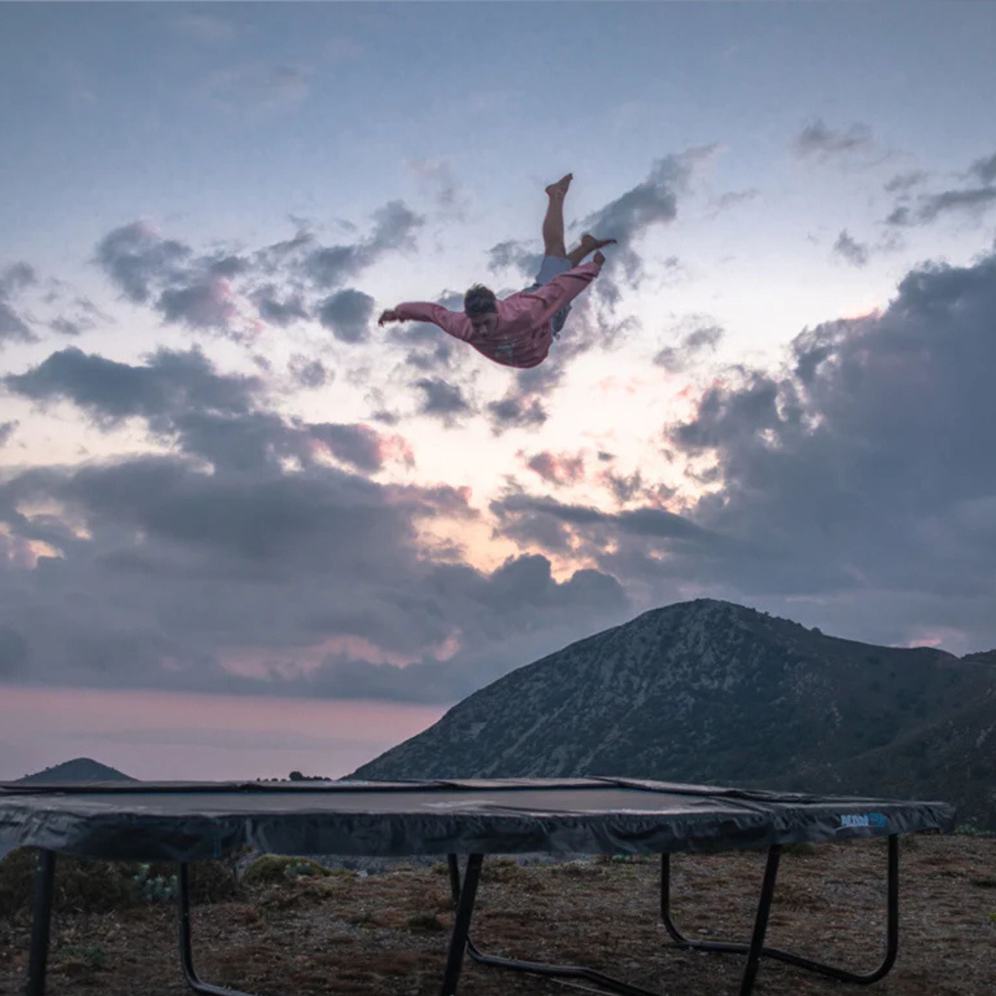 Mann springt auf sturmsicherem Trampolin