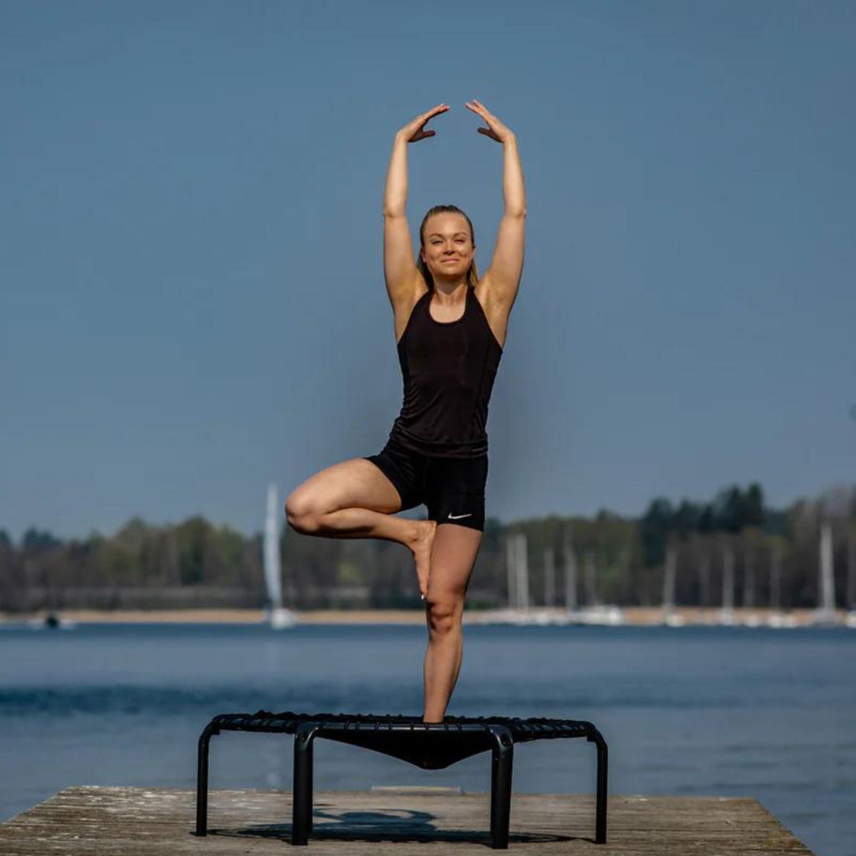 Frau praktiziert Yoga mit Trampolin Bekleidung