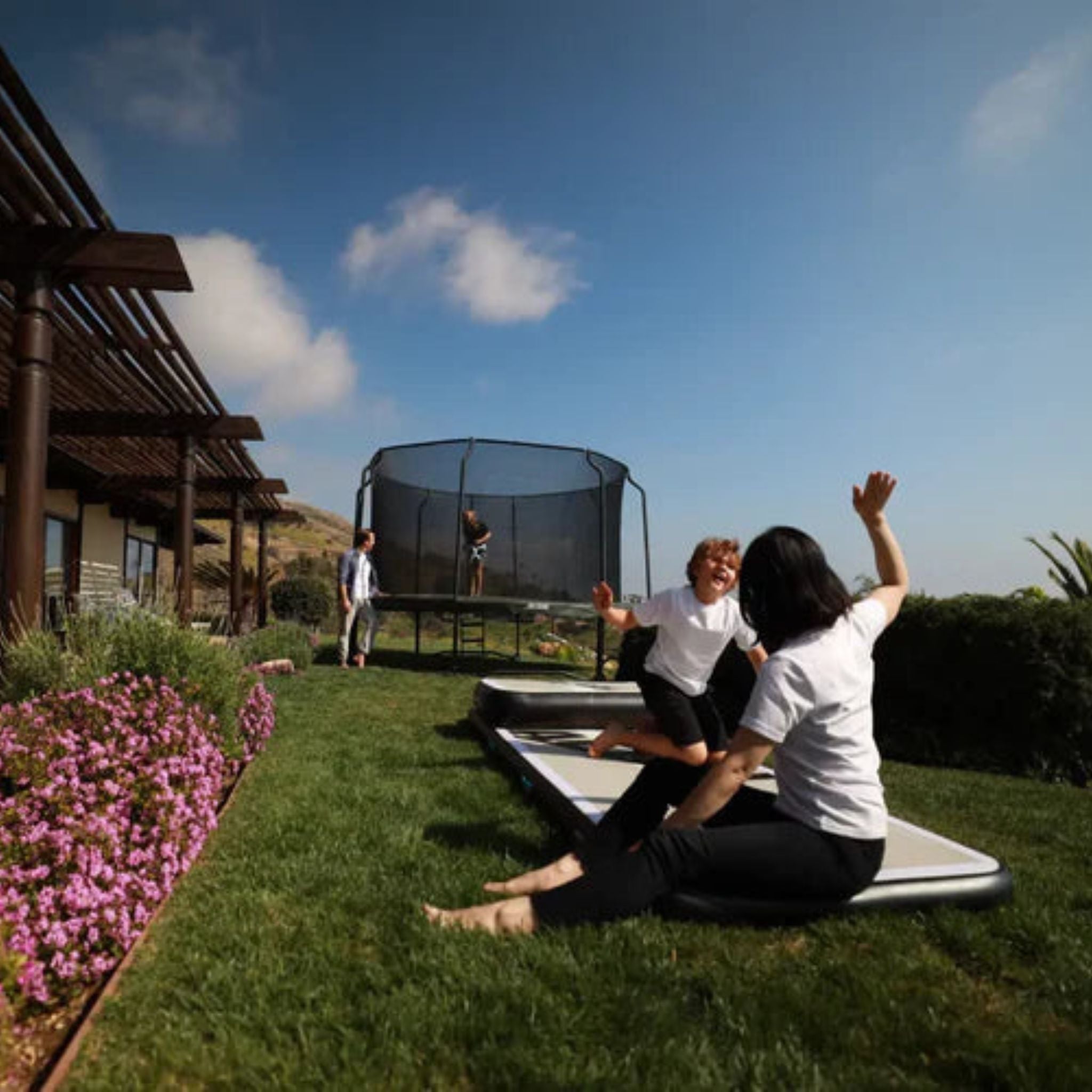 Familie im Garten mit Riesen Trampolin