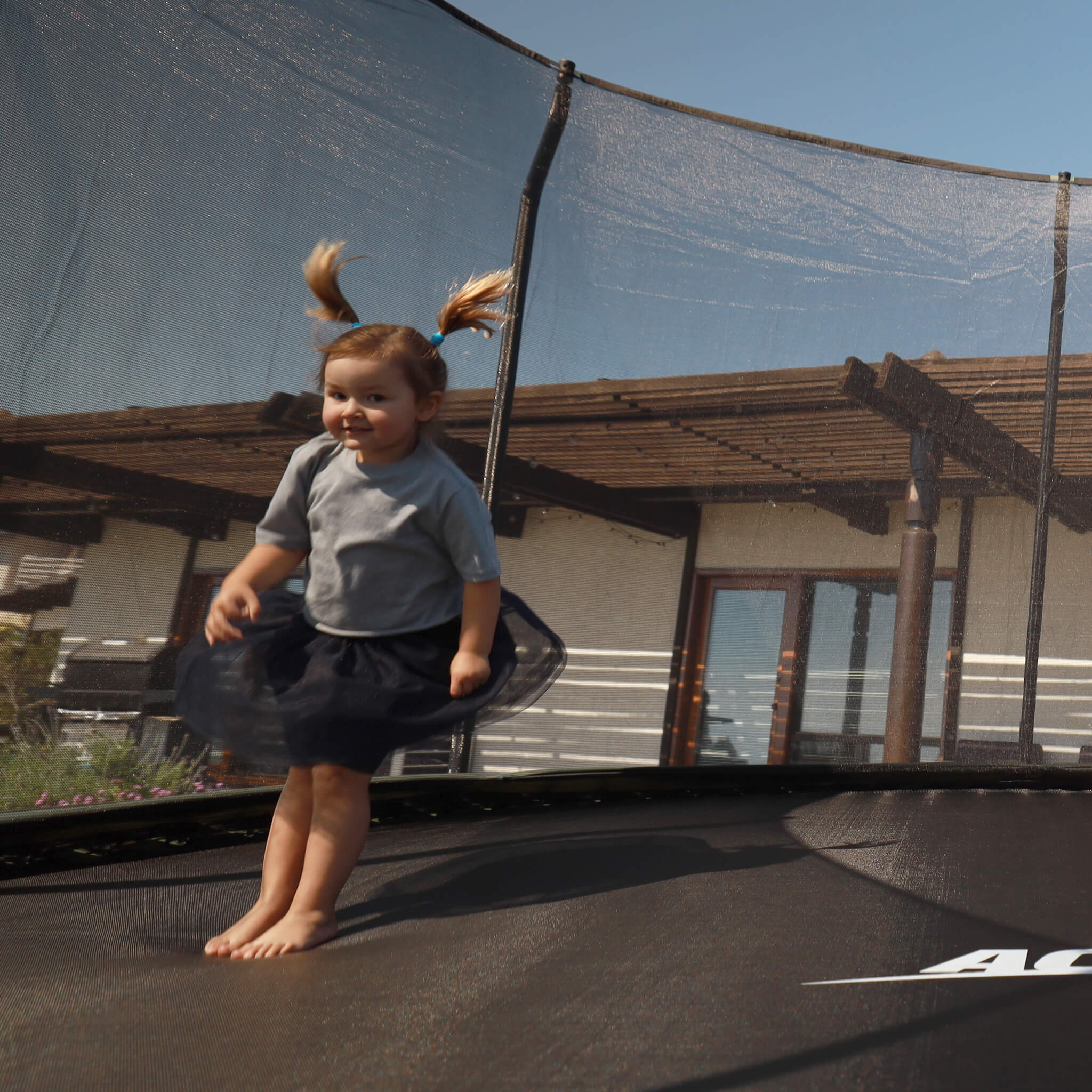 Ein kleines Kind springt auf einem Acon-Trampolin.